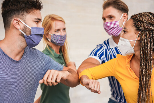 Friends bumping elbows instead of shaking hands.