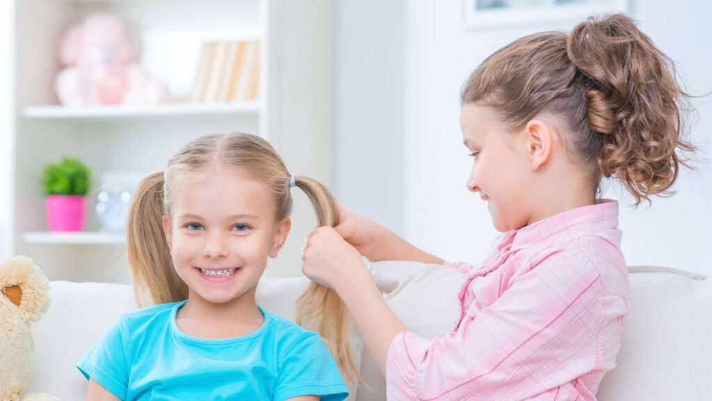 Little girls doing hair.