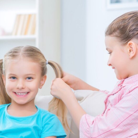 Little girls doing hair.