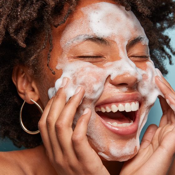 woman washing her face